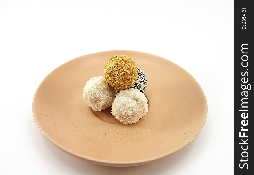 Beautiful sweets on a plate on a white background