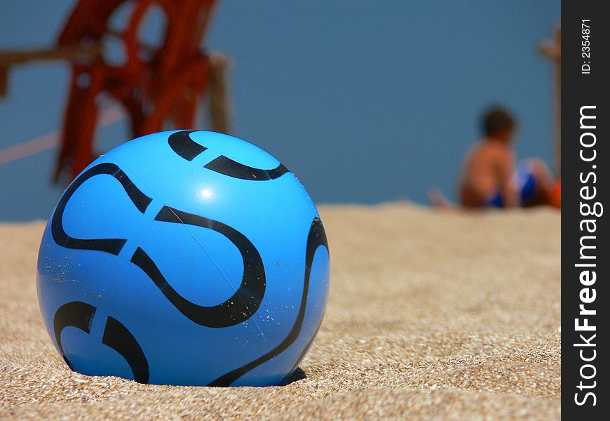 Plastic blue ball to play in the sand