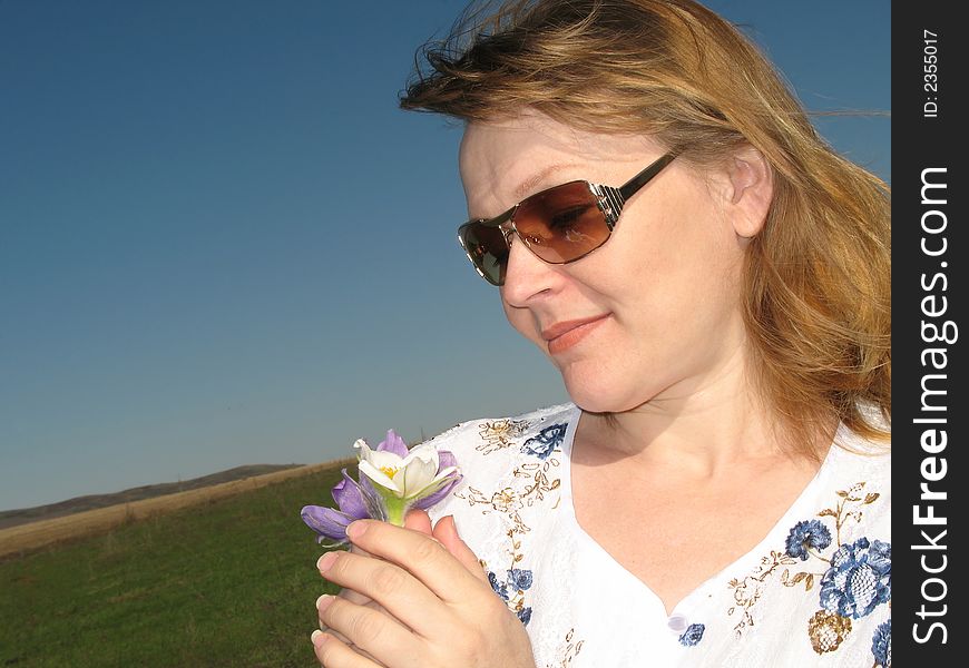 Woman with flowers. Wind rocks the hair