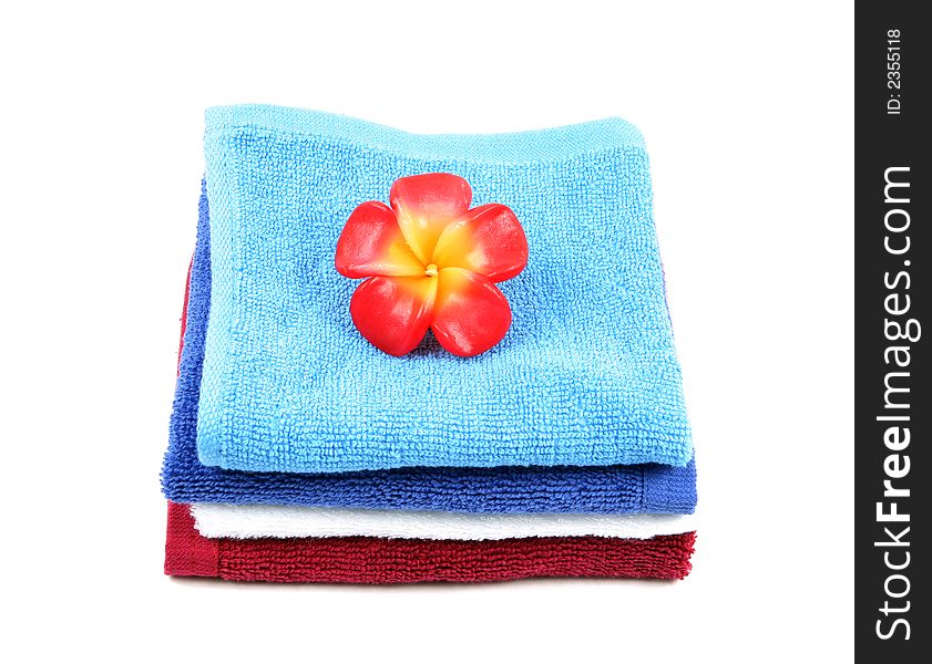 Colorful towels and flower isolated on a white background. Colorful towels and flower isolated on a white background