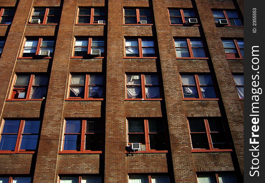 Sun sets on windows of the front wall of art studio building. Sun sets on windows of the front wall of art studio building