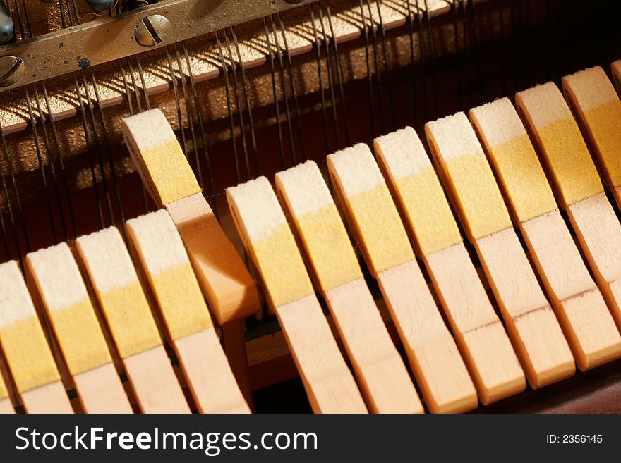 One hammer striking the strings of a piano. One hammer striking the strings of a piano.