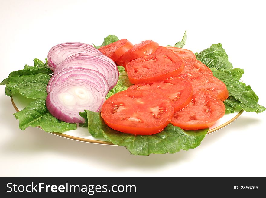 Isolated photo of a sliced tomato and onion on white