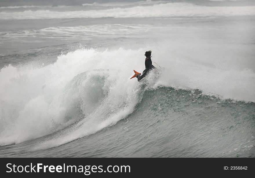 Photo of a bodyboarder on top of the wave