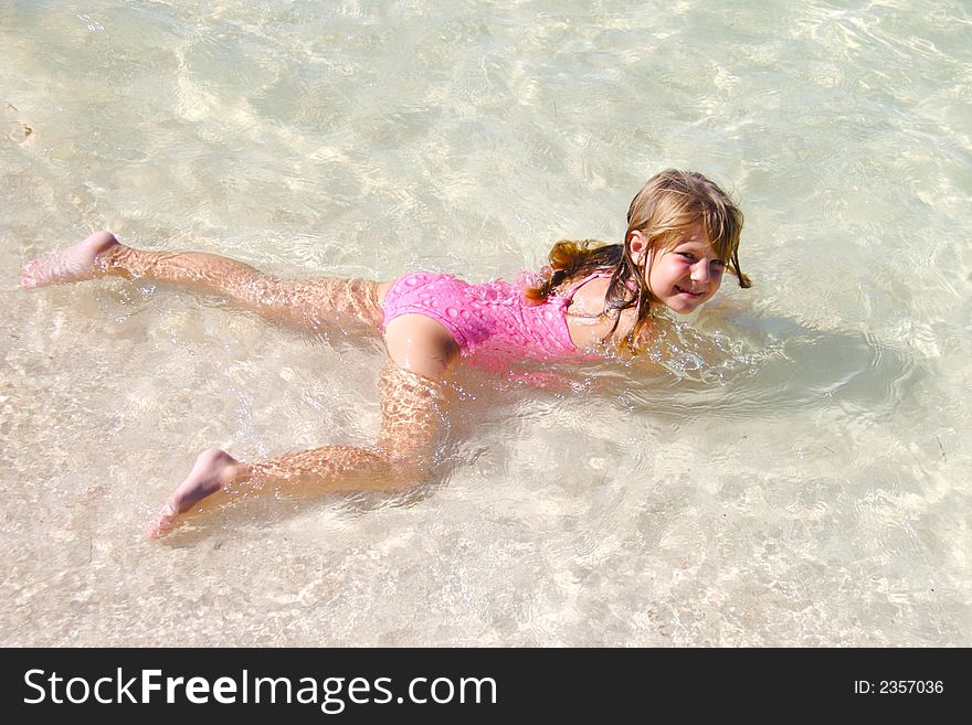 Small girl swimming in the clear water. Small girl swimming in the clear water
