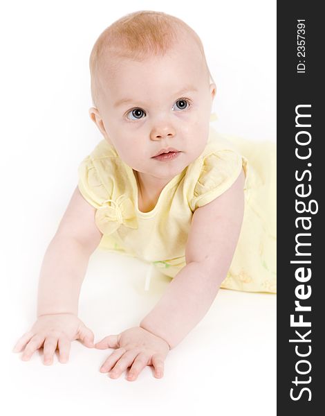 Beautiful one year old baby girl in a yellow dress