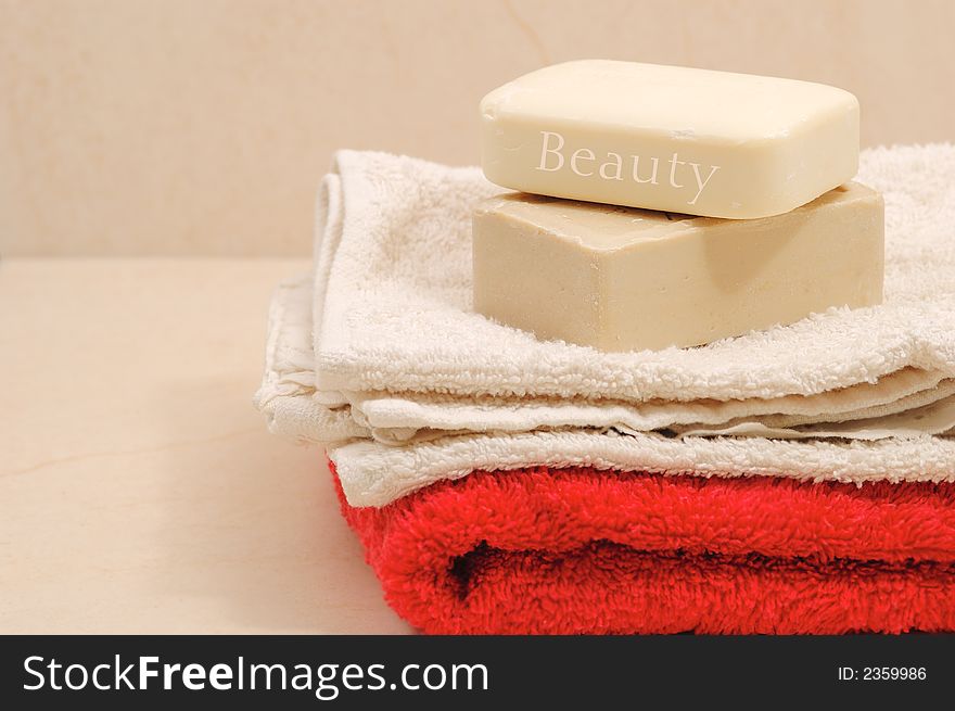 Red and white towels and honey soaps in spa bathroom (spa concept )