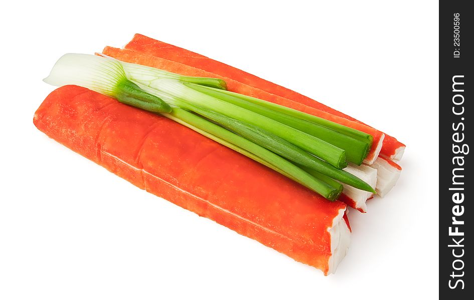 Crab sticks and spring onion against white background