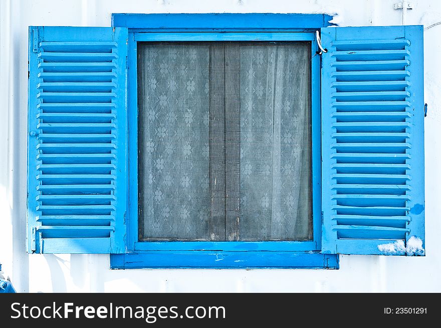 Blue window on white wall on a ship