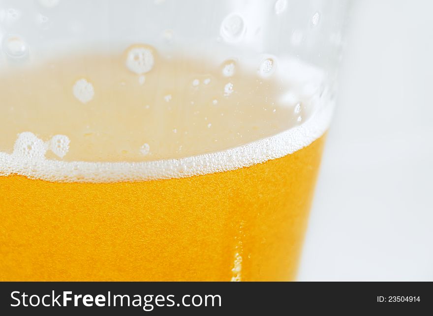 Macro shot of a foaming cold beer ready to drink