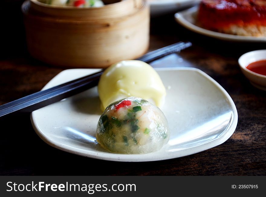 Crystal chives dumpling and  mini buns  on dish. Crystal chives dumpling and  mini buns  on dish