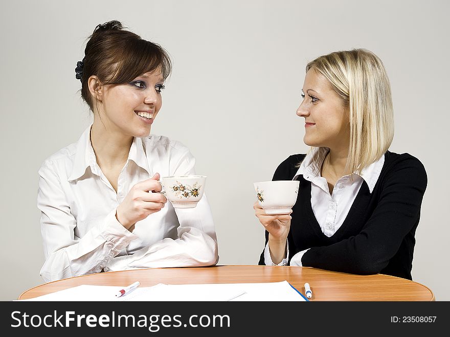 Beautiful girls smiling drink tea sit in the office