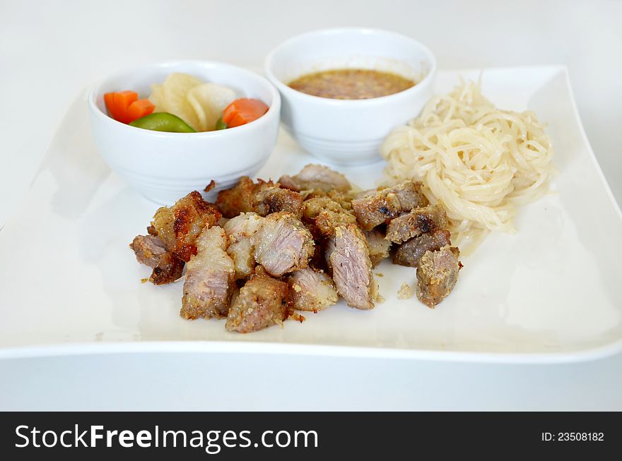 Grilled pork served with sweet sauce and vegetable , noodle. Grilled pork served with sweet sauce and vegetable , noodle