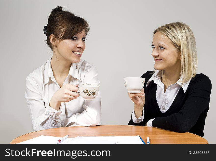 Beautiful girls smiling drink tea sit in the office