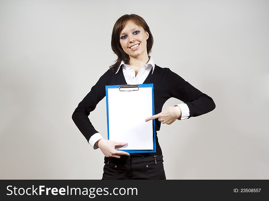 Beautiful girl smiling indicates standing on the document finger. Beautiful girl smiling indicates standing on the document finger