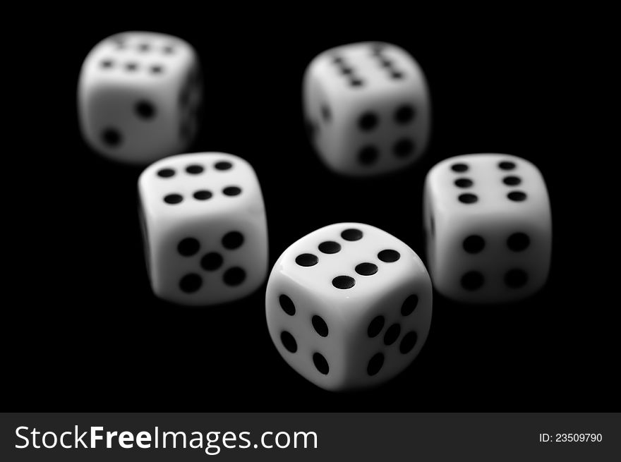 Five dice on black background