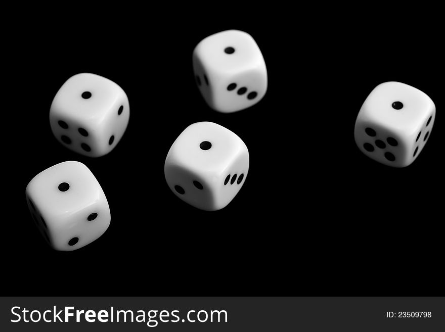 Five dice on black background