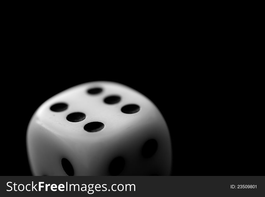 A dice on black background