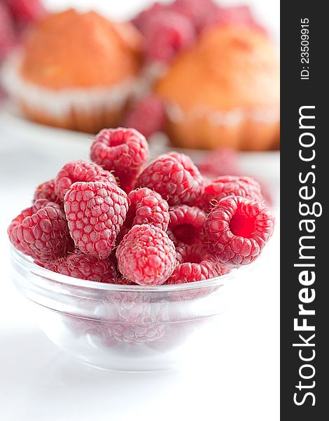Bowl of raspberries on wooden table. Bowl of raspberries on wooden table