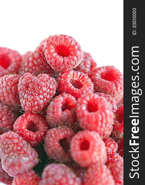 Bowl of raspberries on wooden table close up