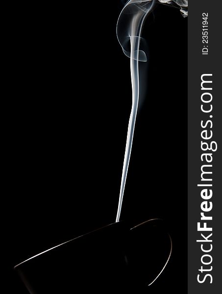 Cup of steaming hot coffee over black background. Cup of steaming hot coffee over black background