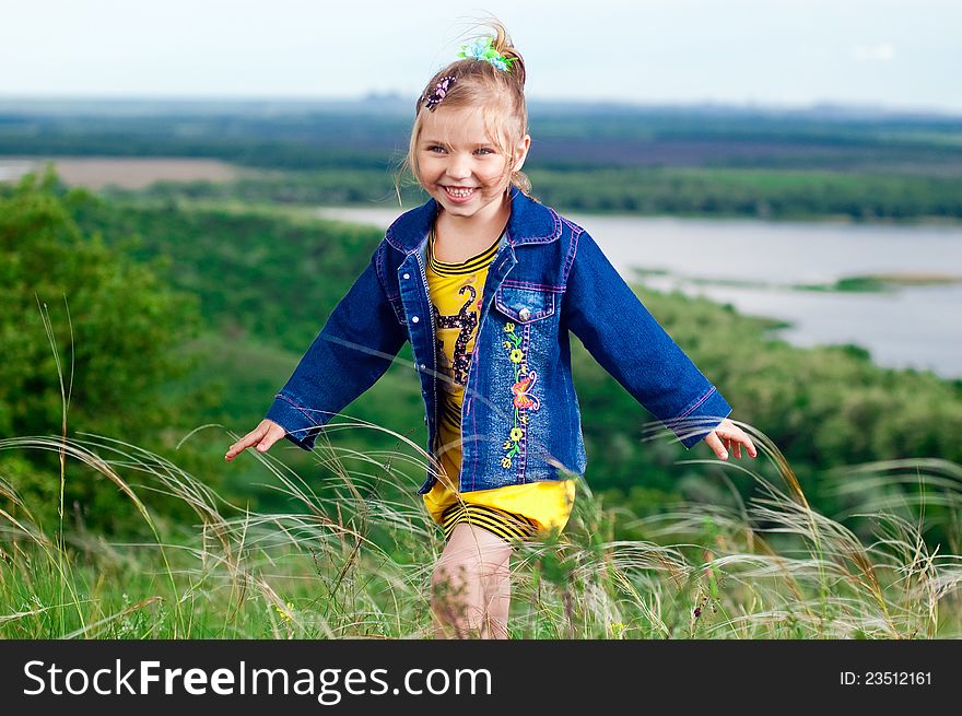 Beautiful little girl in jean clothes on a walk outdoors. Beautiful little girl in jean clothes on a walk outdoors