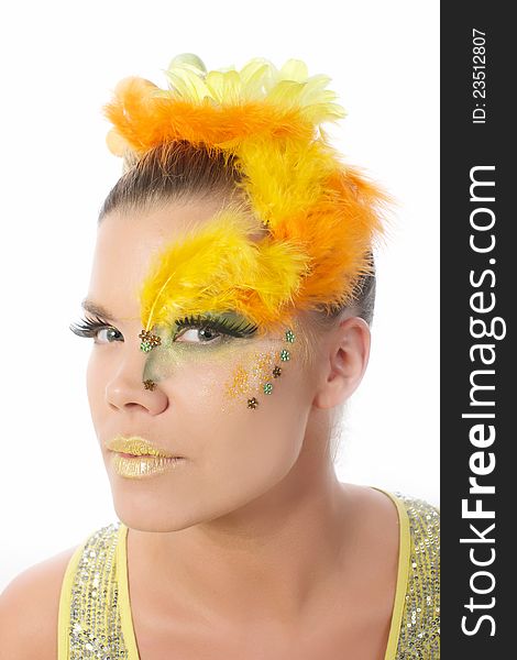 Picture of an easter girl dressed in yellow, with eggs in her hair looking into the camera, on a white, isolated background