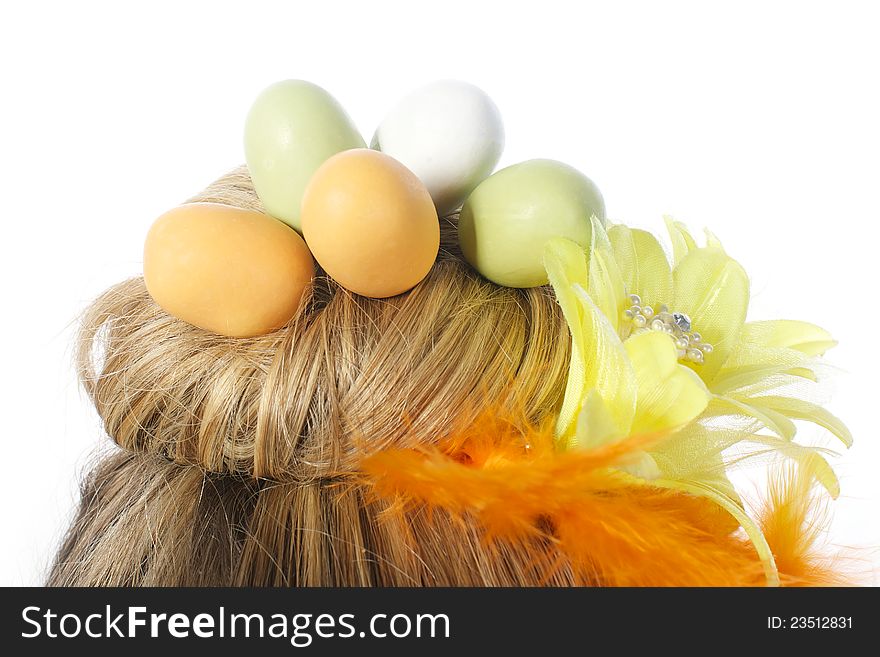 Picture of a girls hair formed as a nest, with easter eggs in it, on a white, isolated background. Picture of a girls hair formed as a nest, with easter eggs in it, on a white, isolated background