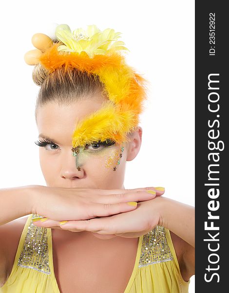 Picture of an easter girl dressed in yellow, with eggs in her hair, on a white, isolated background