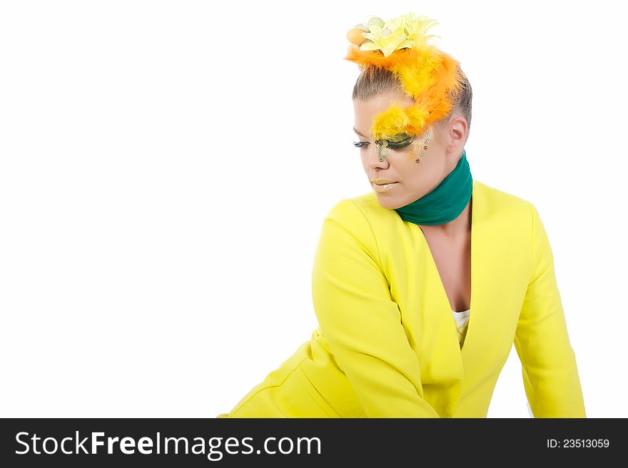 Picture of an easter girl dressed in yellow, with eggs in her hair, looking down to the left, on a white, isolated background