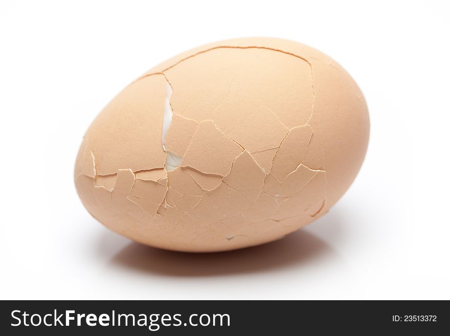 Cracked breakfast egg on white