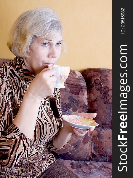 Tea party. Woman relaxing drinks tea