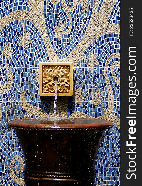Water fountain on abstract pattern wall