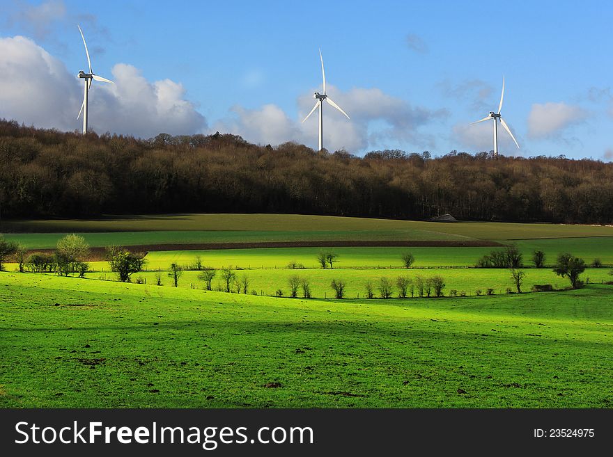 Electrical power generating wind turbines on a beautiful landscape. Electrical power generating wind turbines on a beautiful landscape.