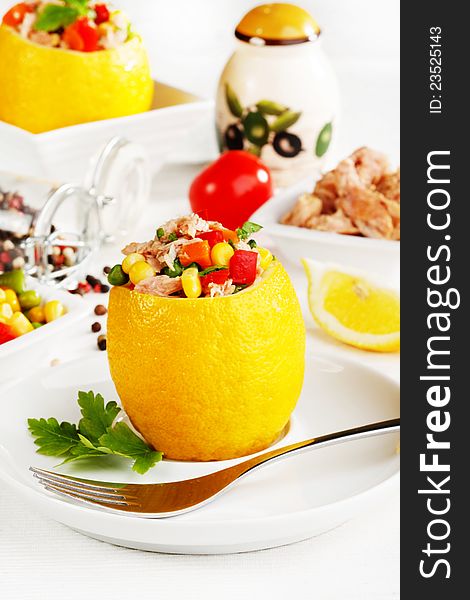 Mixed vegetable salad with tuna in lemon basket. Mixed vegetable salad with tuna in lemon basket
