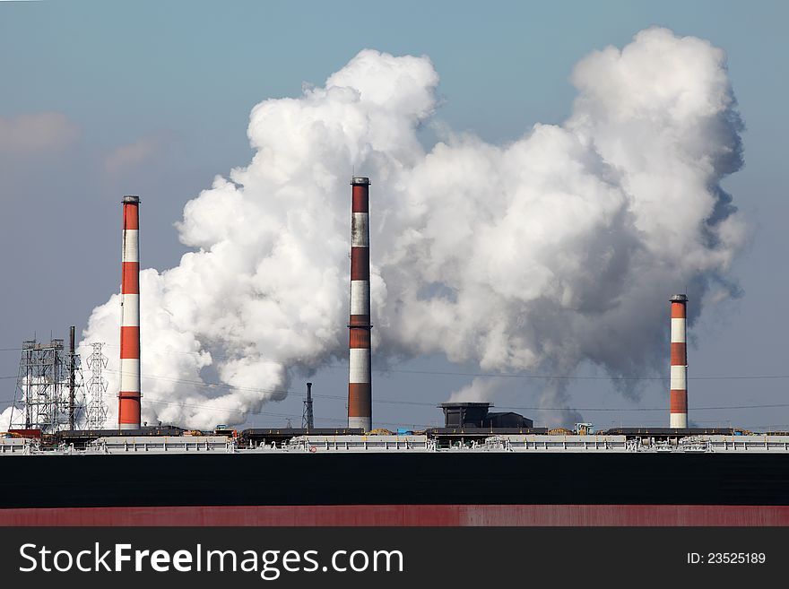 Air polluting smokestack with white smoke