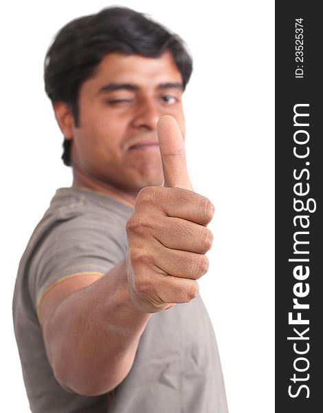 Portrait of happy young Indian giving thumbs up over white background