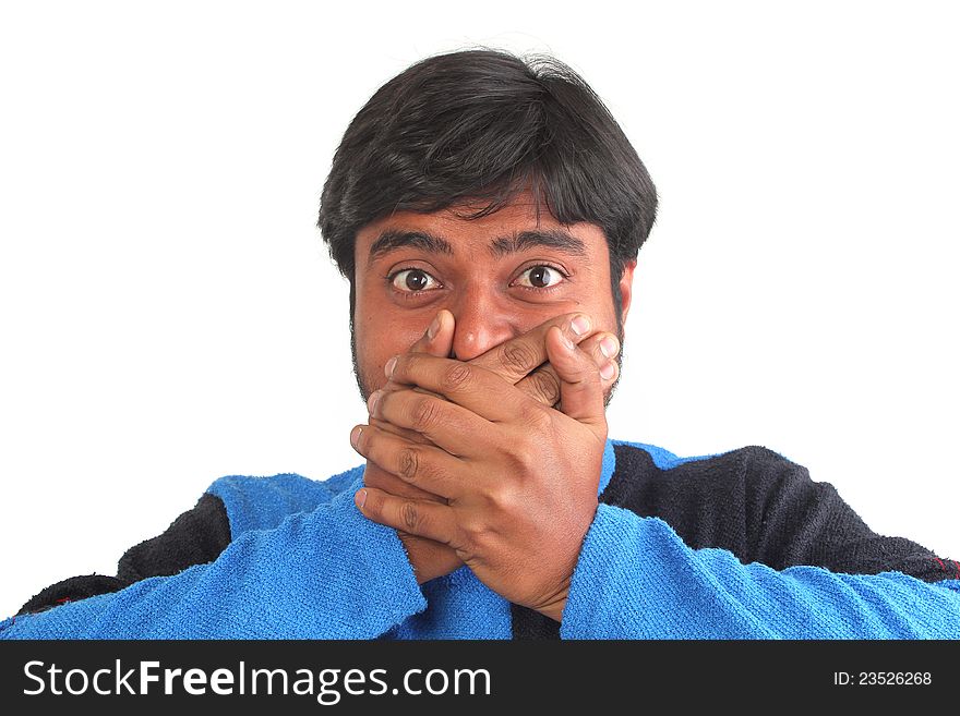 Young south indian youth holding his mouth with hands showing facial expression of disbelief or surprise. Young south indian youth holding his mouth with hands showing facial expression of disbelief or surprise