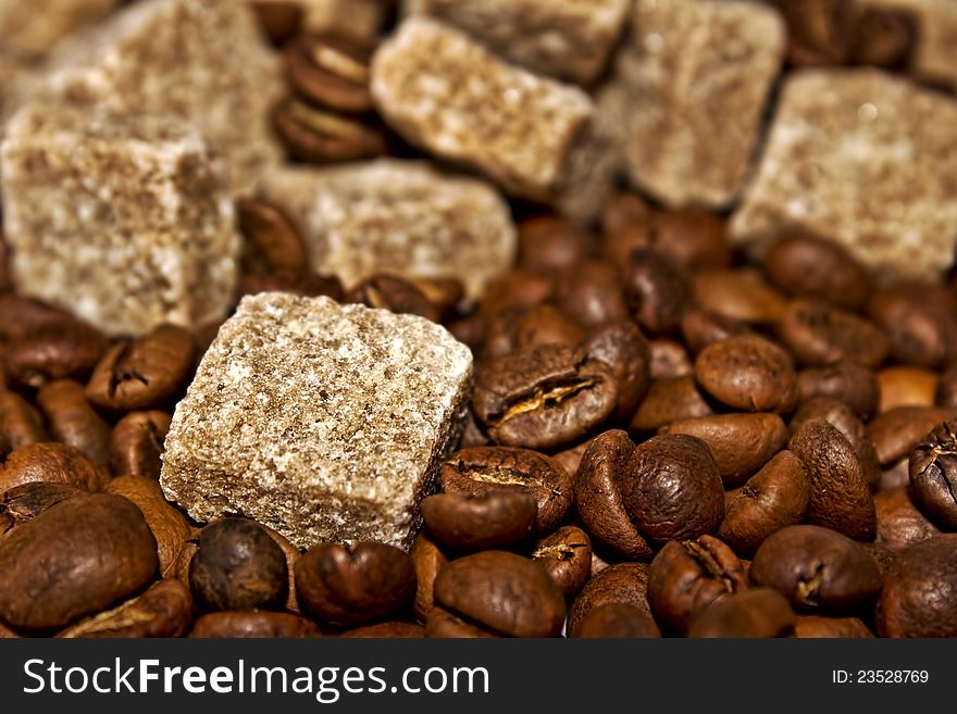 Grains of coffee and pieces of reed sugar. Grains of coffee and pieces of reed sugar
