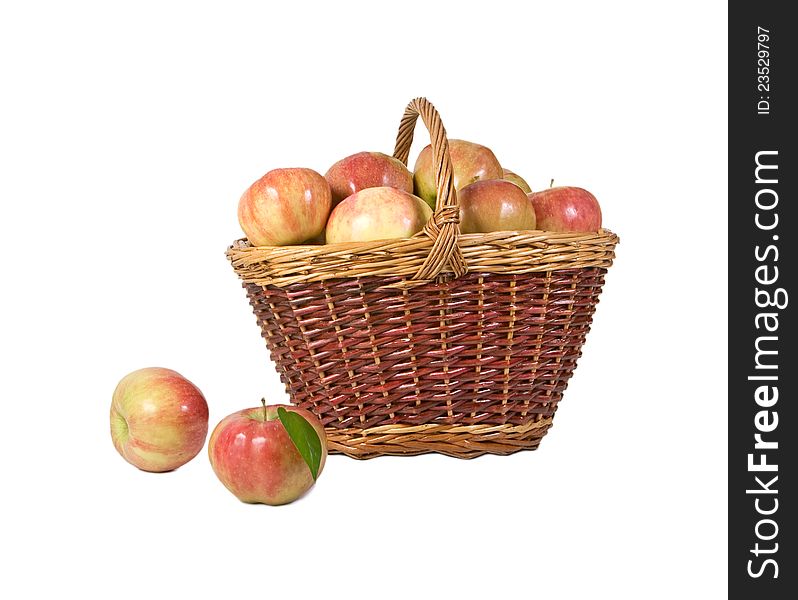 Basket with apples and two apples of lying alongside. Basket with apples and two apples of lying alongside
