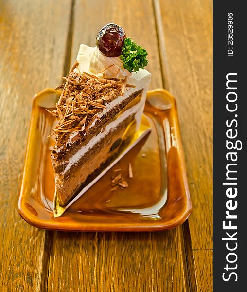 Tasty chocolate cake on wood table