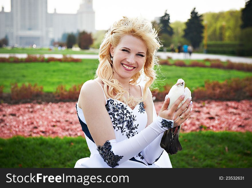 Happy bride with pigeon on the wedding walk