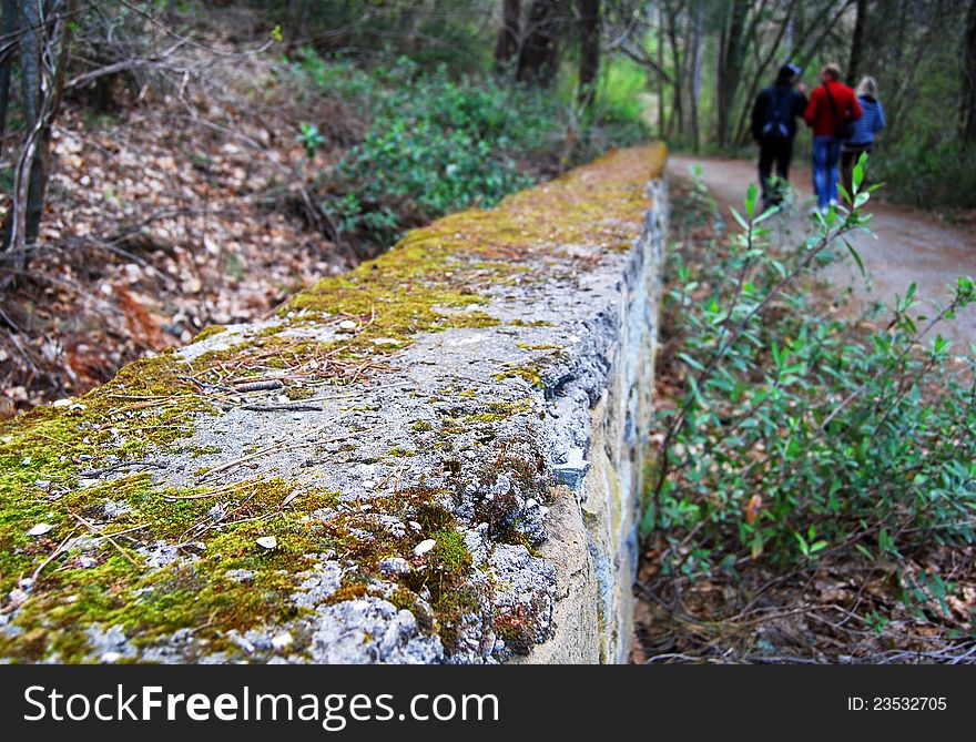 Closeup view on old stone wall at the autumn park alley. Closeup view on old stone wall at the autumn park alley