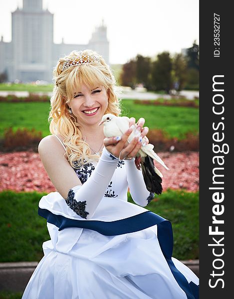 Happy bride with pigeon on the wedding walk