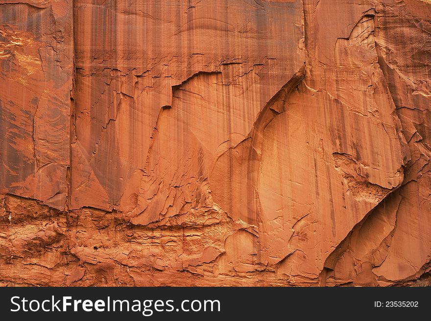 A massive wall of sandstone exhibits stains and various textures in southern Utah. A massive wall of sandstone exhibits stains and various textures in southern Utah.
