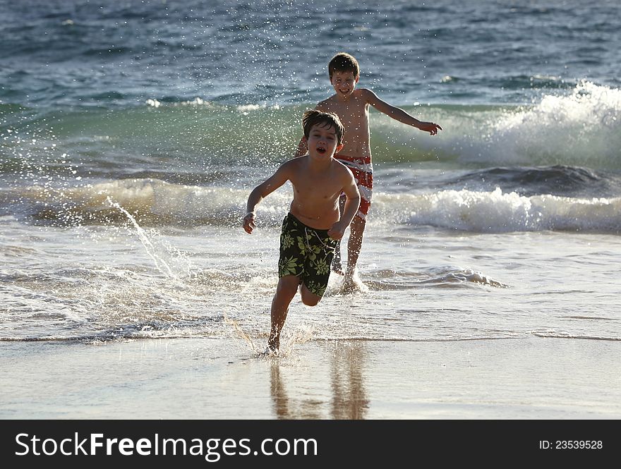Two cute boys having fun at the ocean