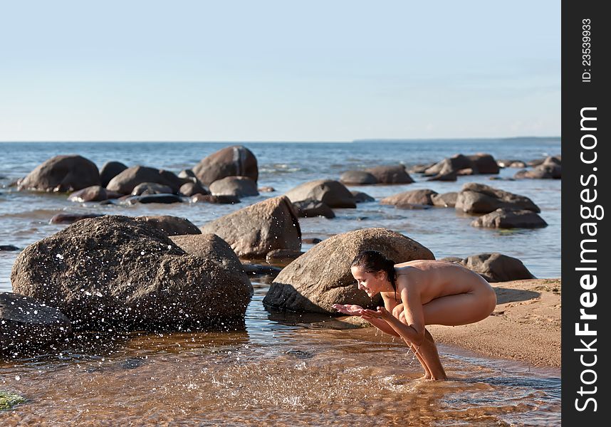 Nude Woman Playing With Water
