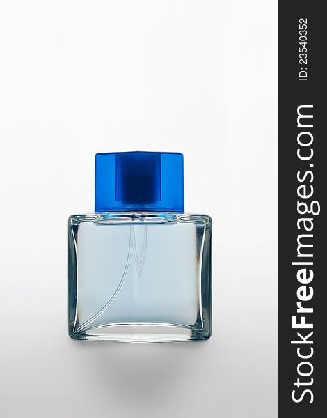 Studio shot of a perfume bottle with blue cap on white matte background with shadow