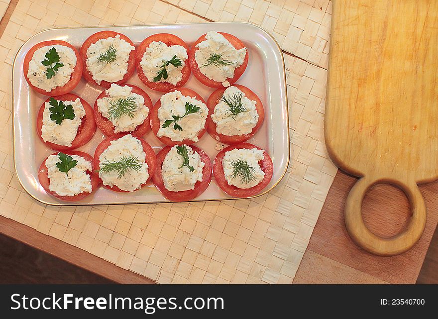 Home-made fresh tomatoes stuffed with sour cream and herbs. Russian cuisine. Home-made fresh tomatoes stuffed with sour cream and herbs. Russian cuisine