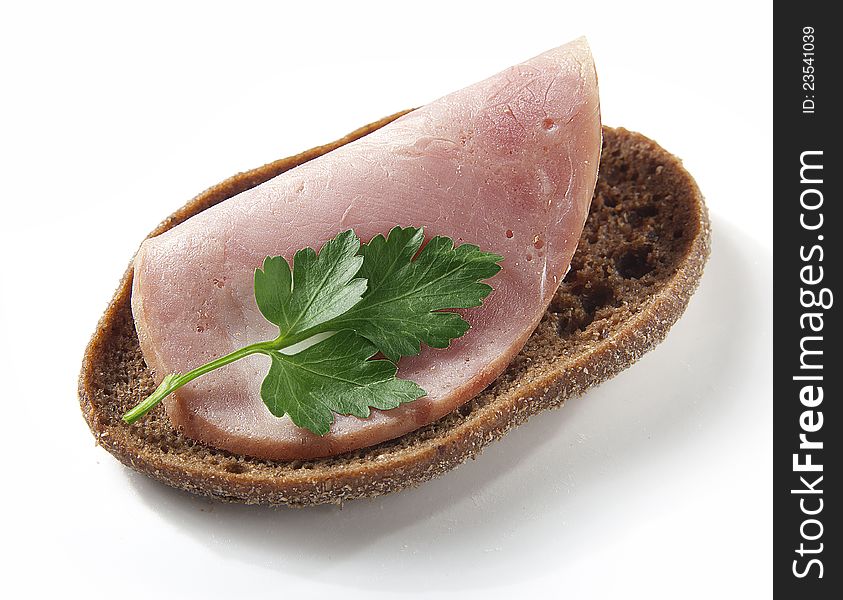 Sandwich with ham and parsley on the white
